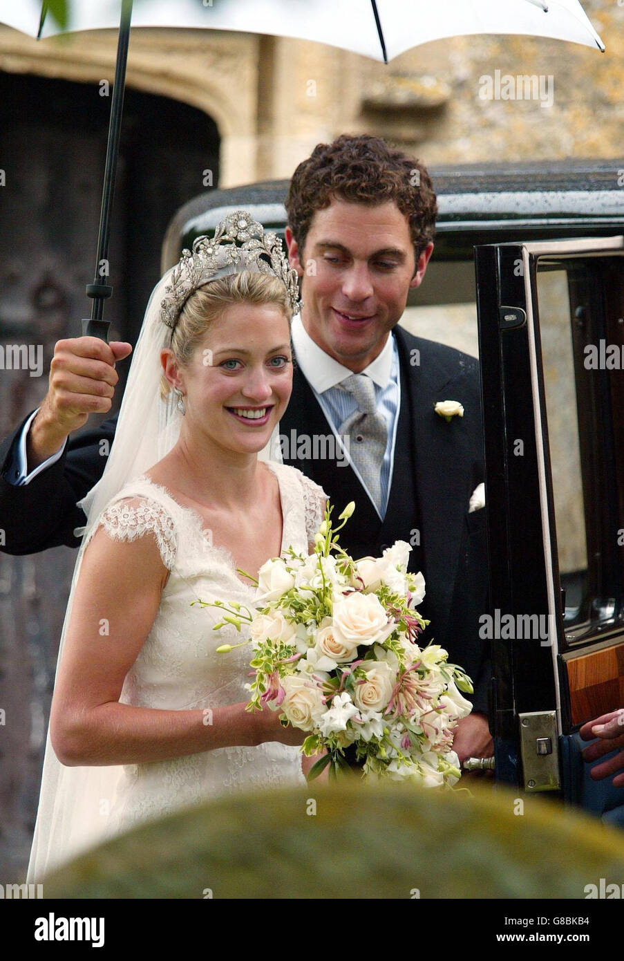 Hugh Van Cutsem holds an umberella for his new bride Rose Astor after their  wedding Stock Photo - Alamy