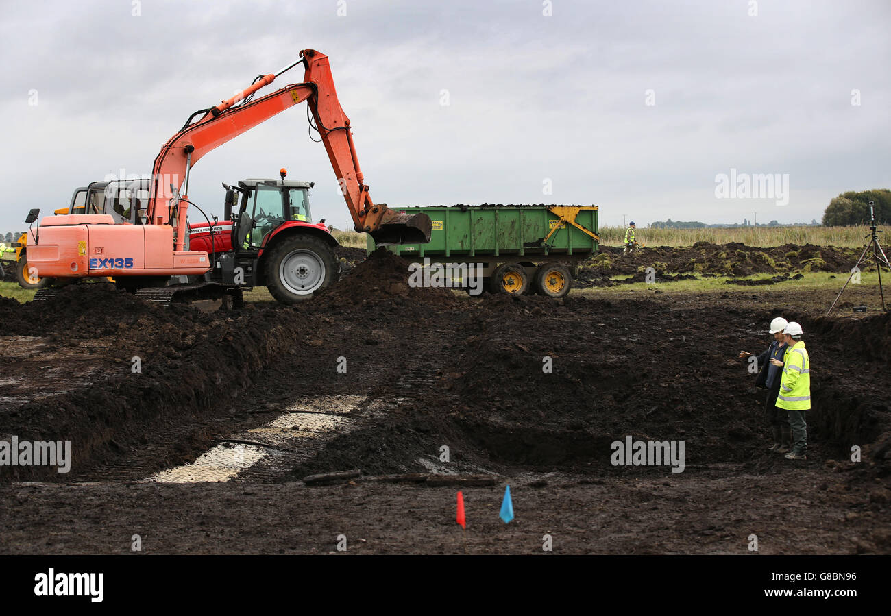 Archaeologists excavating a site near Holme Lode Farm in Cambridgeshire to recover the first artefacts from a Spitfire which has lain buried in a field for 75 years since it crashed during the Second World War. Stock Photo
