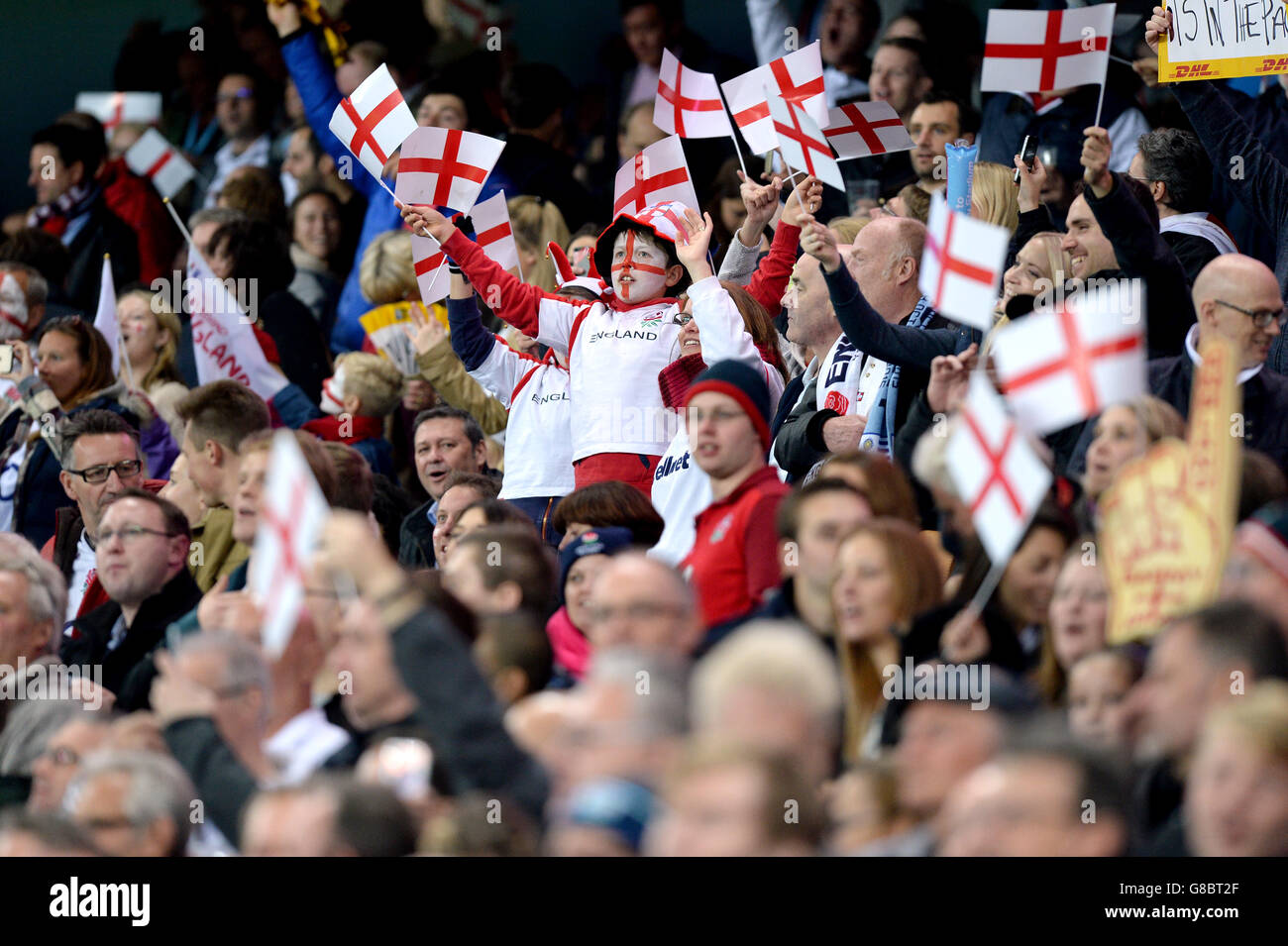 England fans waving flags in the stands during the Rugby World Cup match at the City of Manchester Stadium. Stock Photo