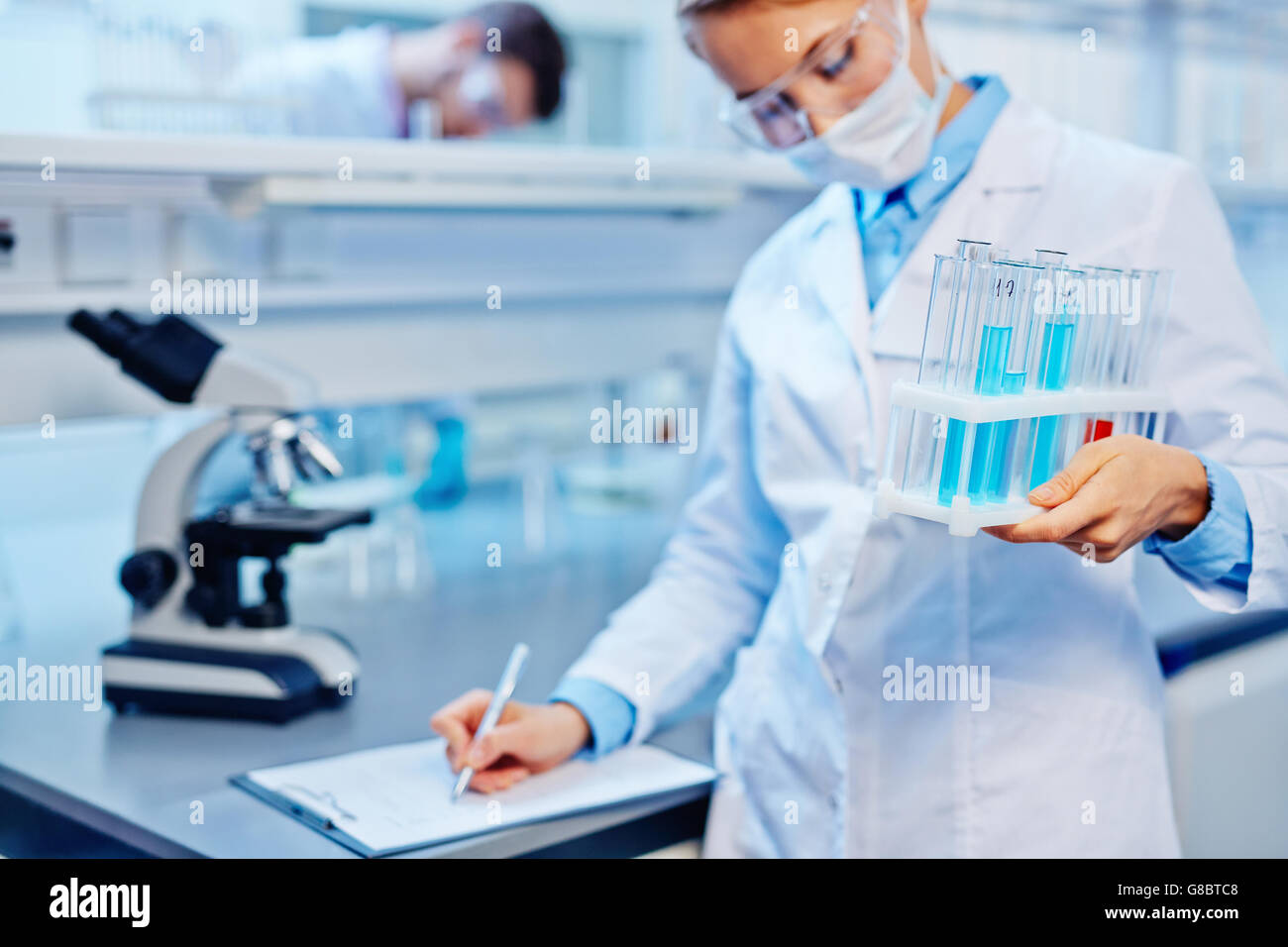 Female lab assistant flask hi-res stock photography and images - Alamy