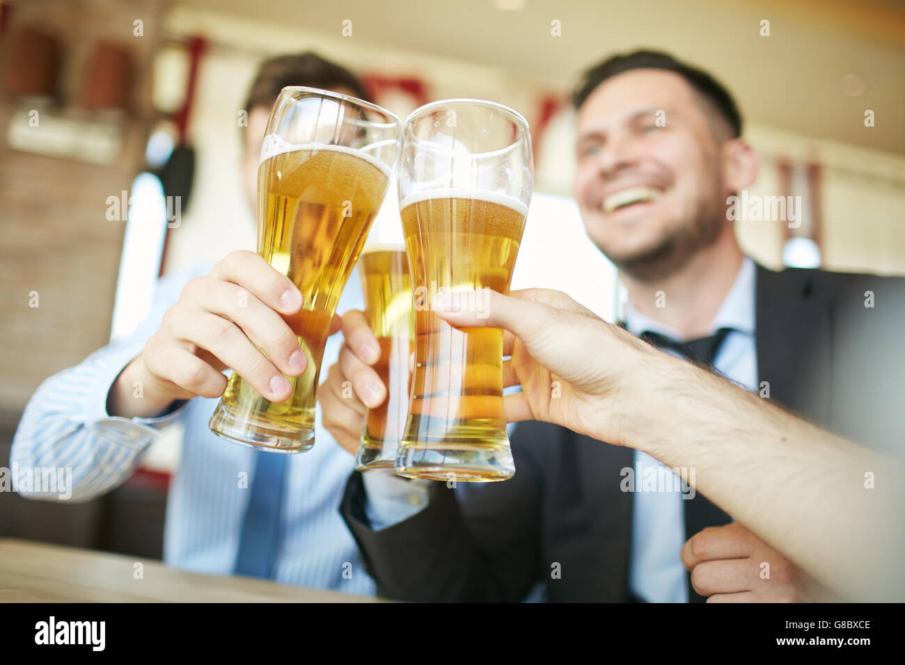 Clinking glasses of beer Stock Photo
