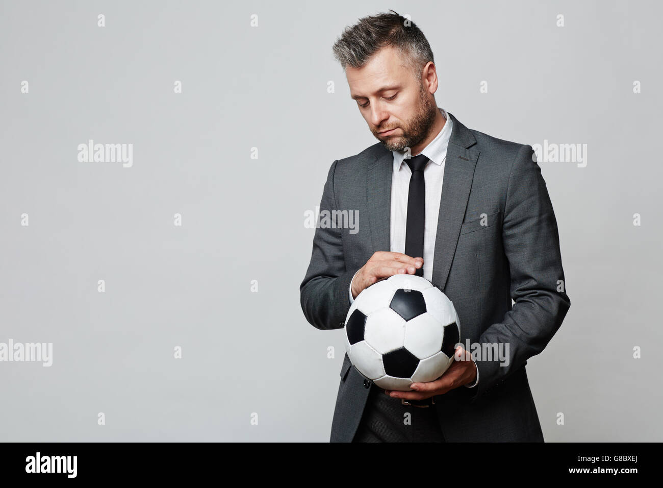 Businessman with soccer ball Stock Photo - Alamy