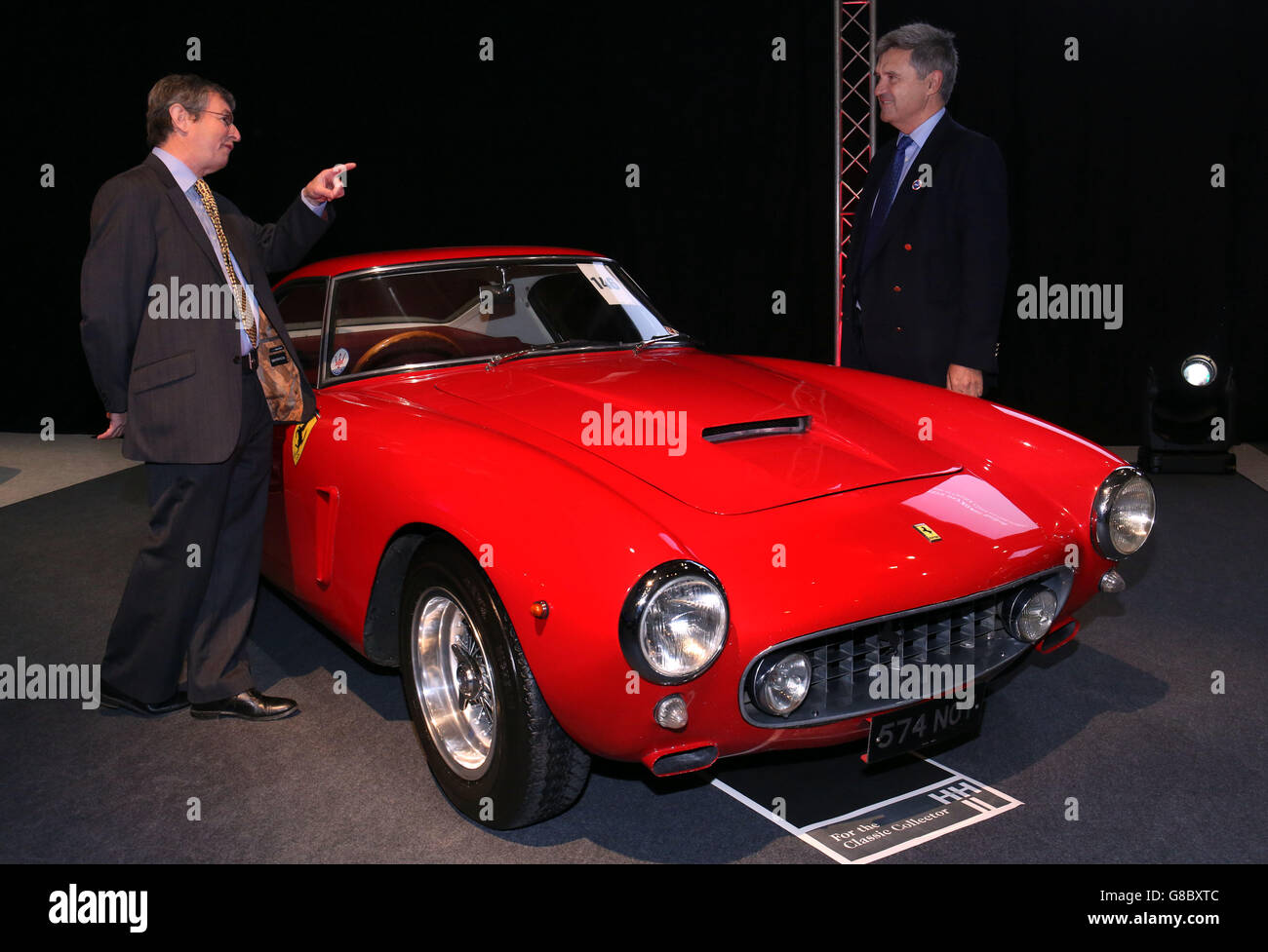 (L to R) Charles Denton, godson and executor to the estate of the late Richard Colton with RNLI Chief Executive Paul Boissier, stand next to a 1960 Ferrari 250 GT short-wheelbase (SWB) Berlinetta chassis 1995 GT, of which just 167 were made with a mere ten being supplied new to the UK market, one of the star lots with no reserve, on display prior to the H&H Classics, classic cars and motorcycles sale, at the Imperial War Museum, Duxford, one of two of the rarest and most sought-after Ferraris ever made which are being sold to raise funds for the Royal National Lifeboat Institution (RNLI). Stock Photo