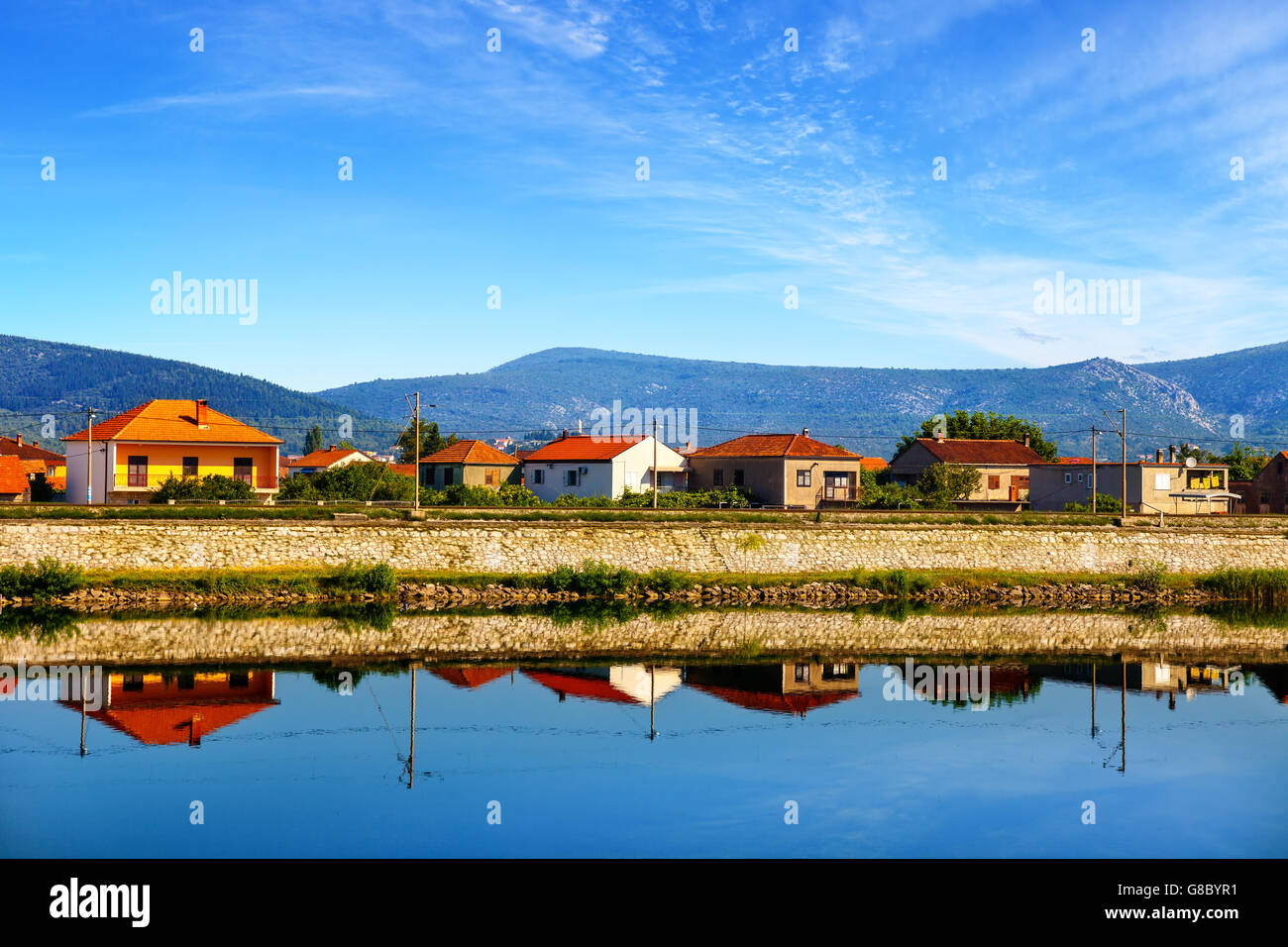 Rows of houses along the Neretva river. Stock Photo
