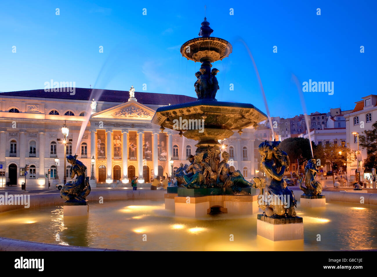 Fountain and National theater in Rossio square at night in Lisbon Stock Photo