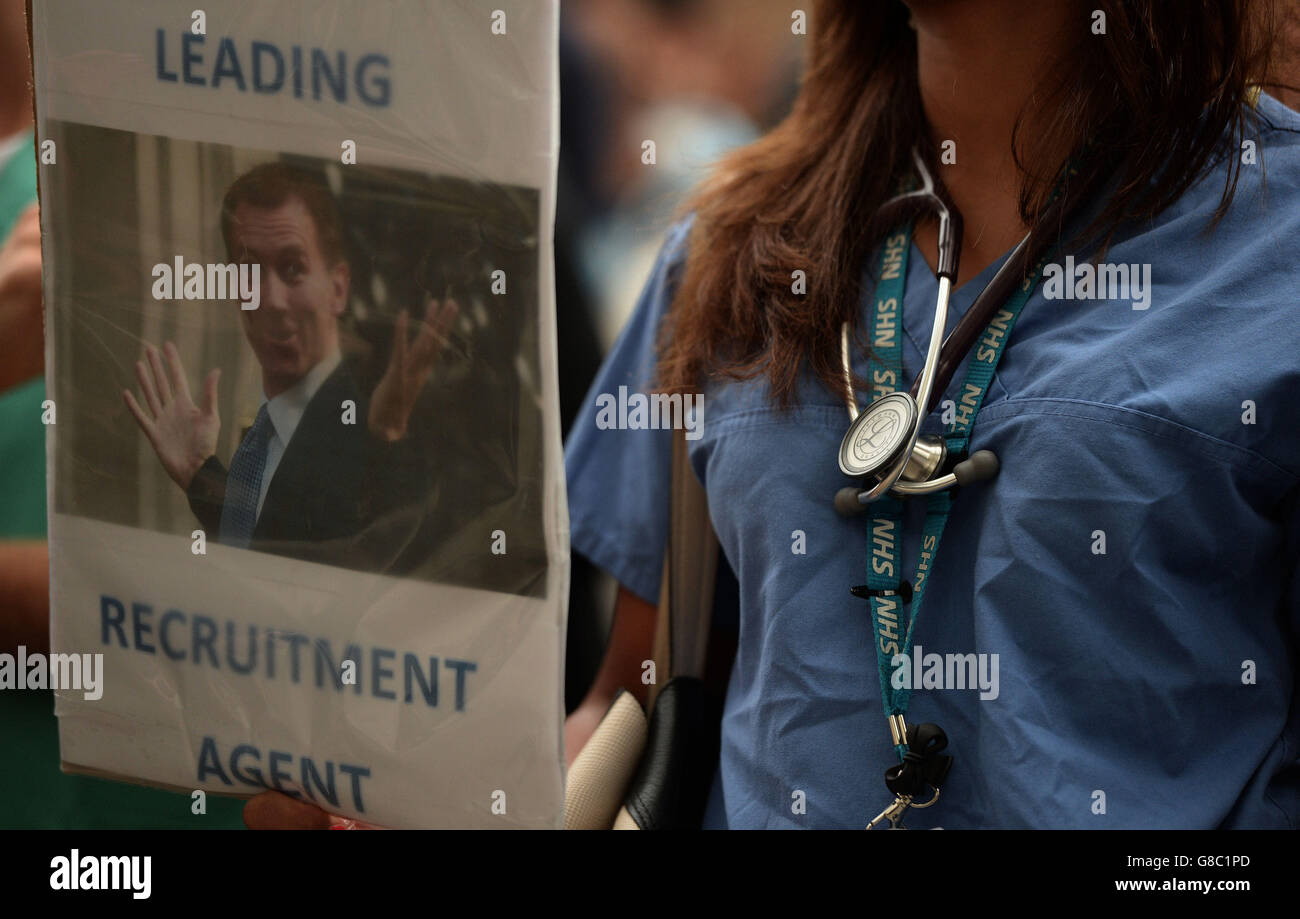 A woman holds a placard during the 'Let's Save the NHS' rally and protest march by junior doctors in London. Stock Photo