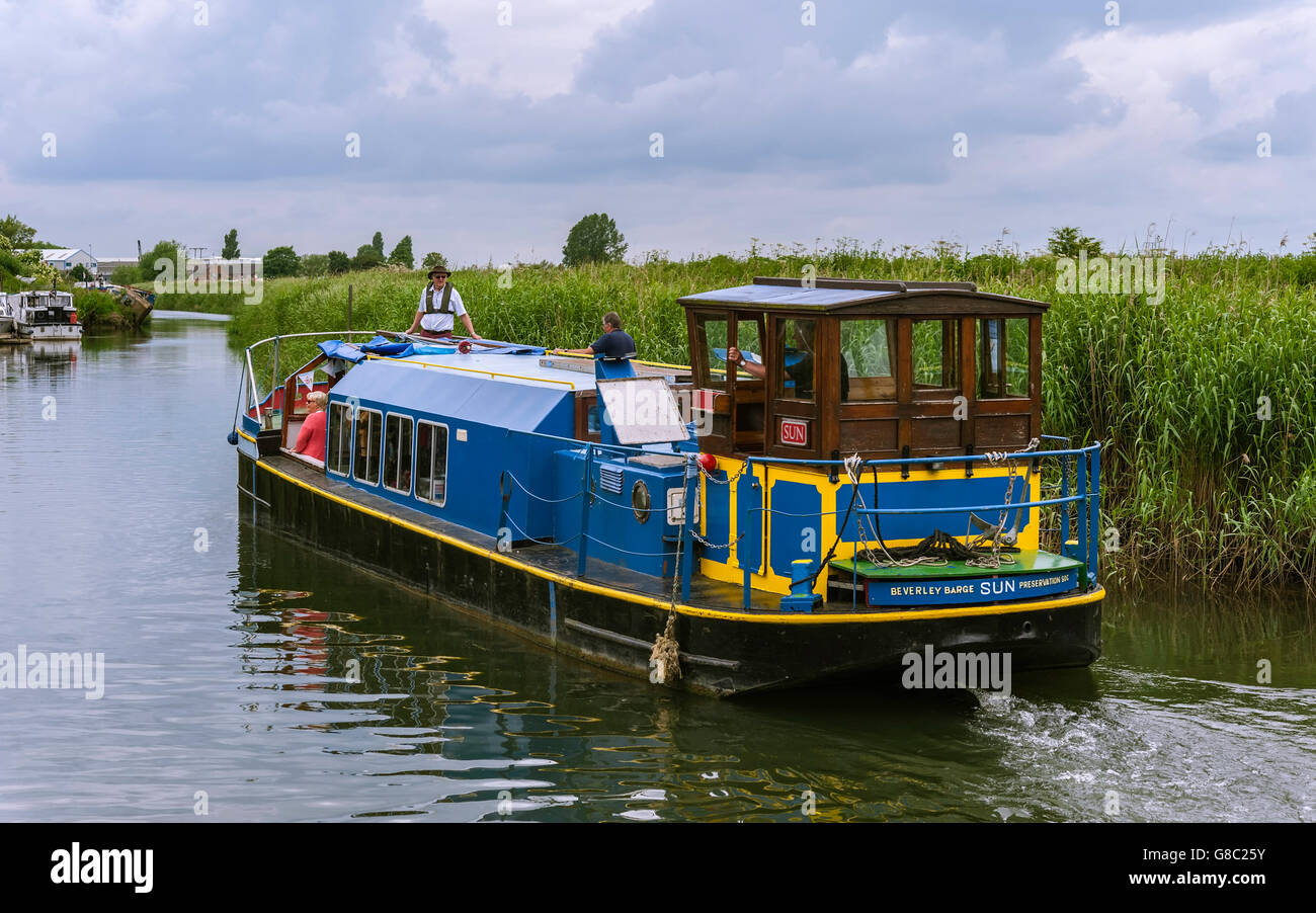 Passengers enjoy an excursion on the renovated barge, The Sun, along the River Hull at the confluence with the Beck. Stock Photo