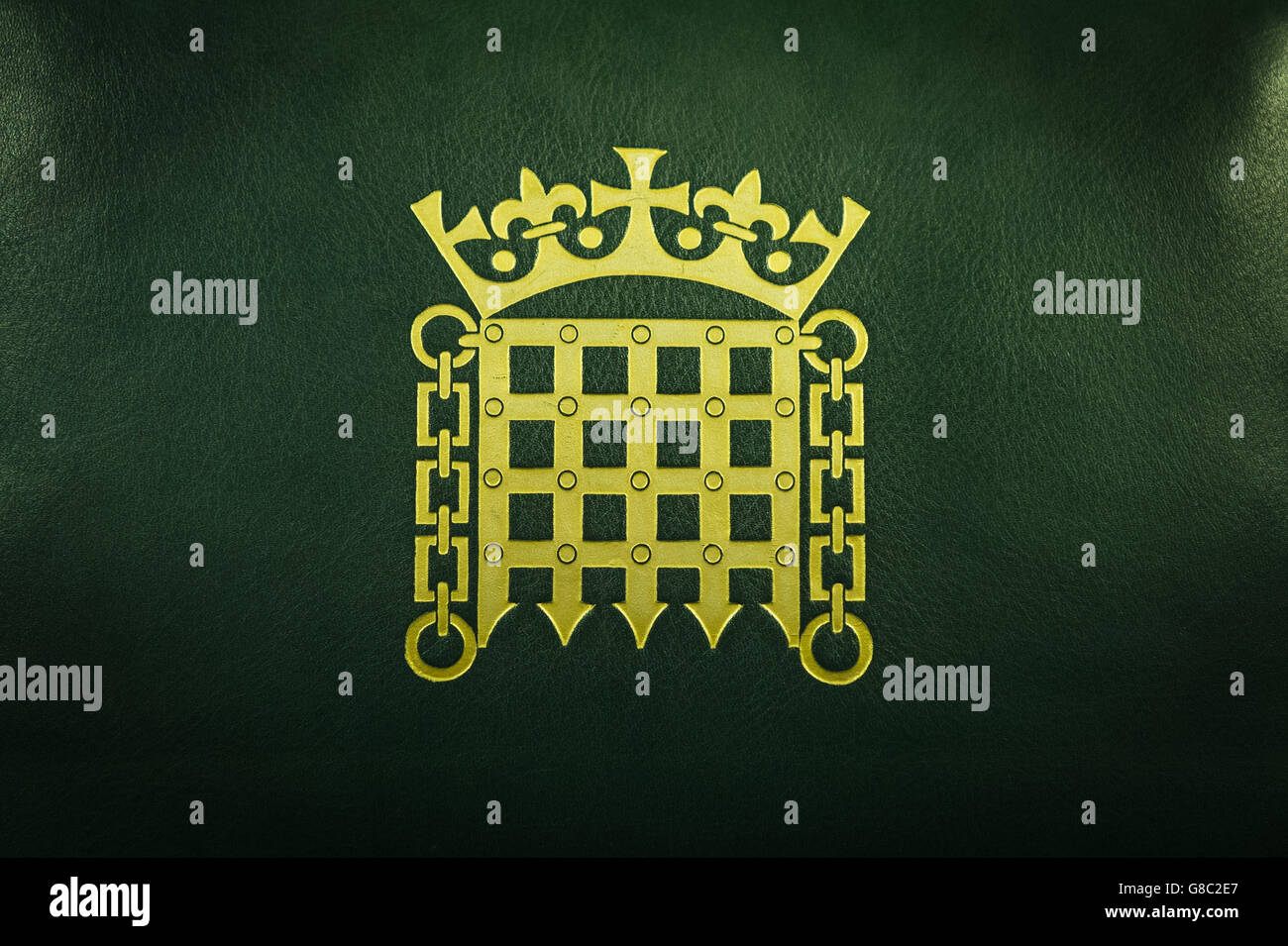 A Crowned Portcullis logo which is the official emblem of the House of Commons on a leather chair. Stock Photo