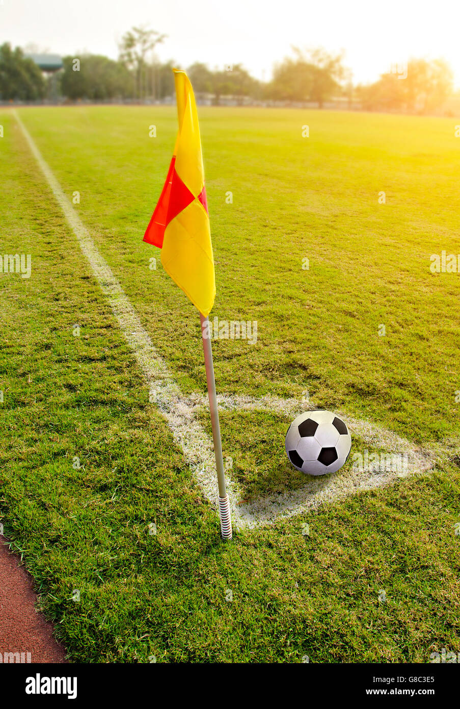 Corner flag with ball on a soccer field Stock Photo