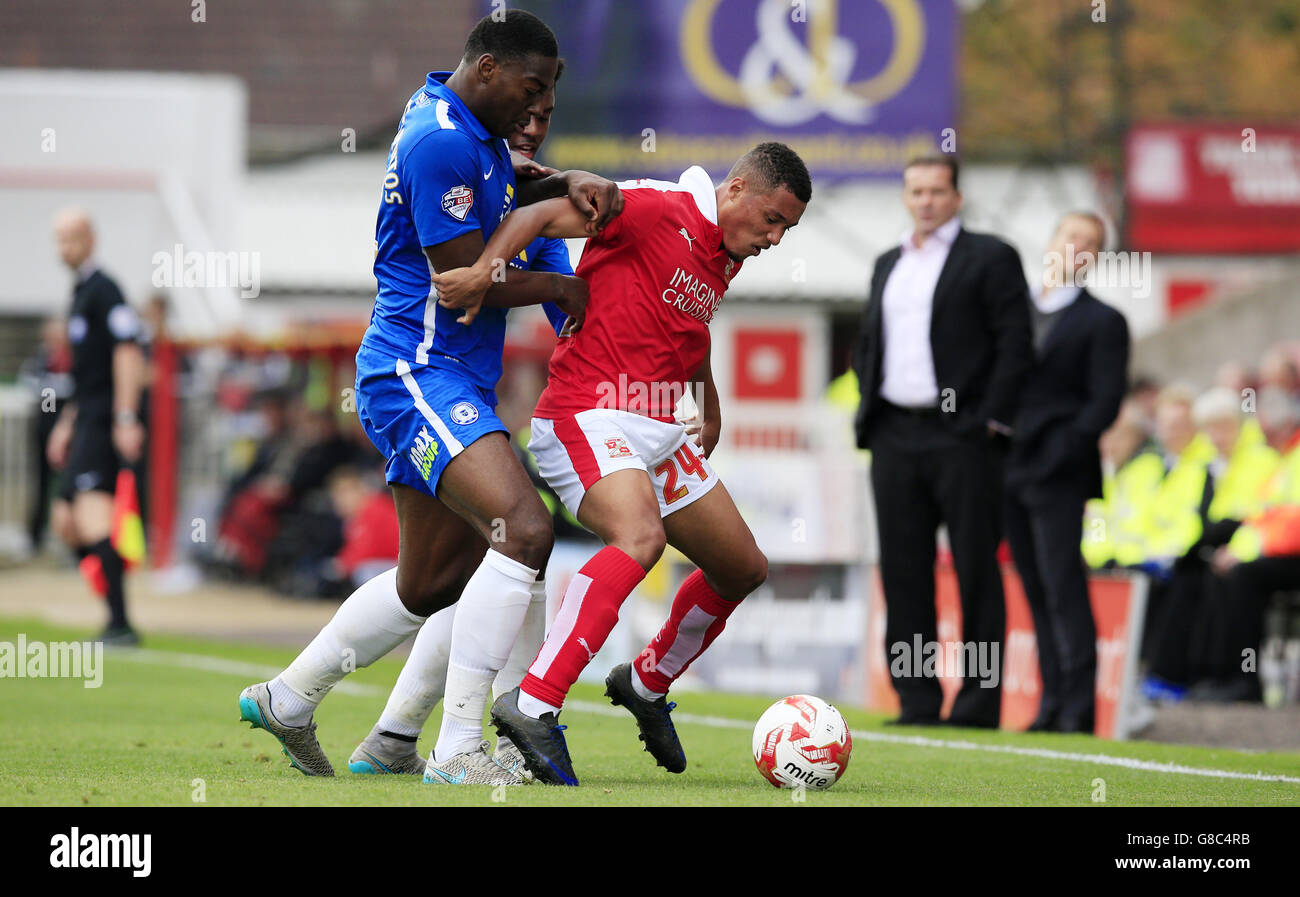 Swindon Town's Jermaine Hylton (right) is held back by Peterbrough's Ricardo Almeida Santos (left) . Stock Photo