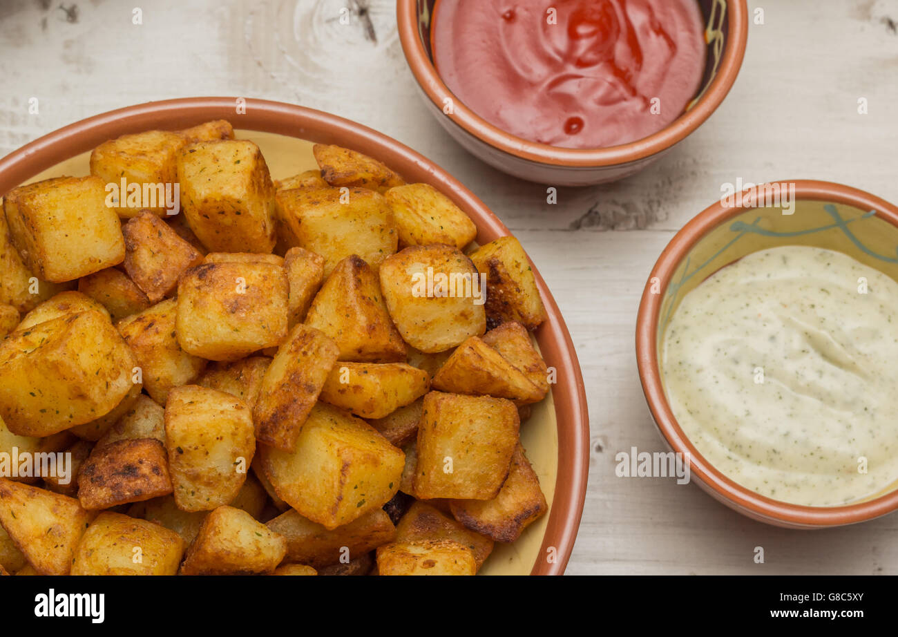 Spanish tapa patatas bravas with hot sauce and aioli Stock Photo