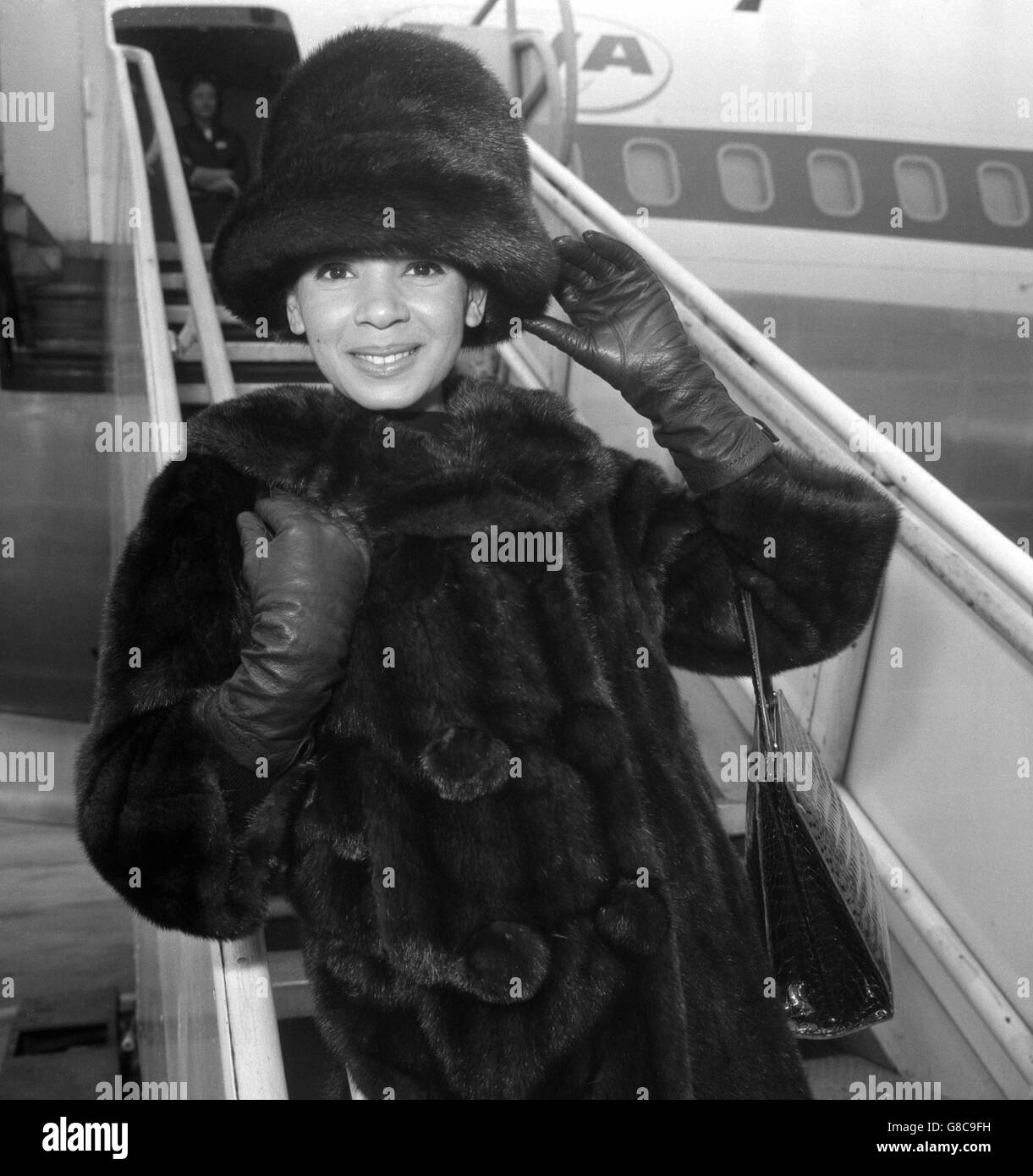 Singer Shirley Bassey is wrapped up warm as she leaves London Airport for New York. She is to appear in a concert at the Carnegie Hall before going on to Australia for two months. Stock Photo