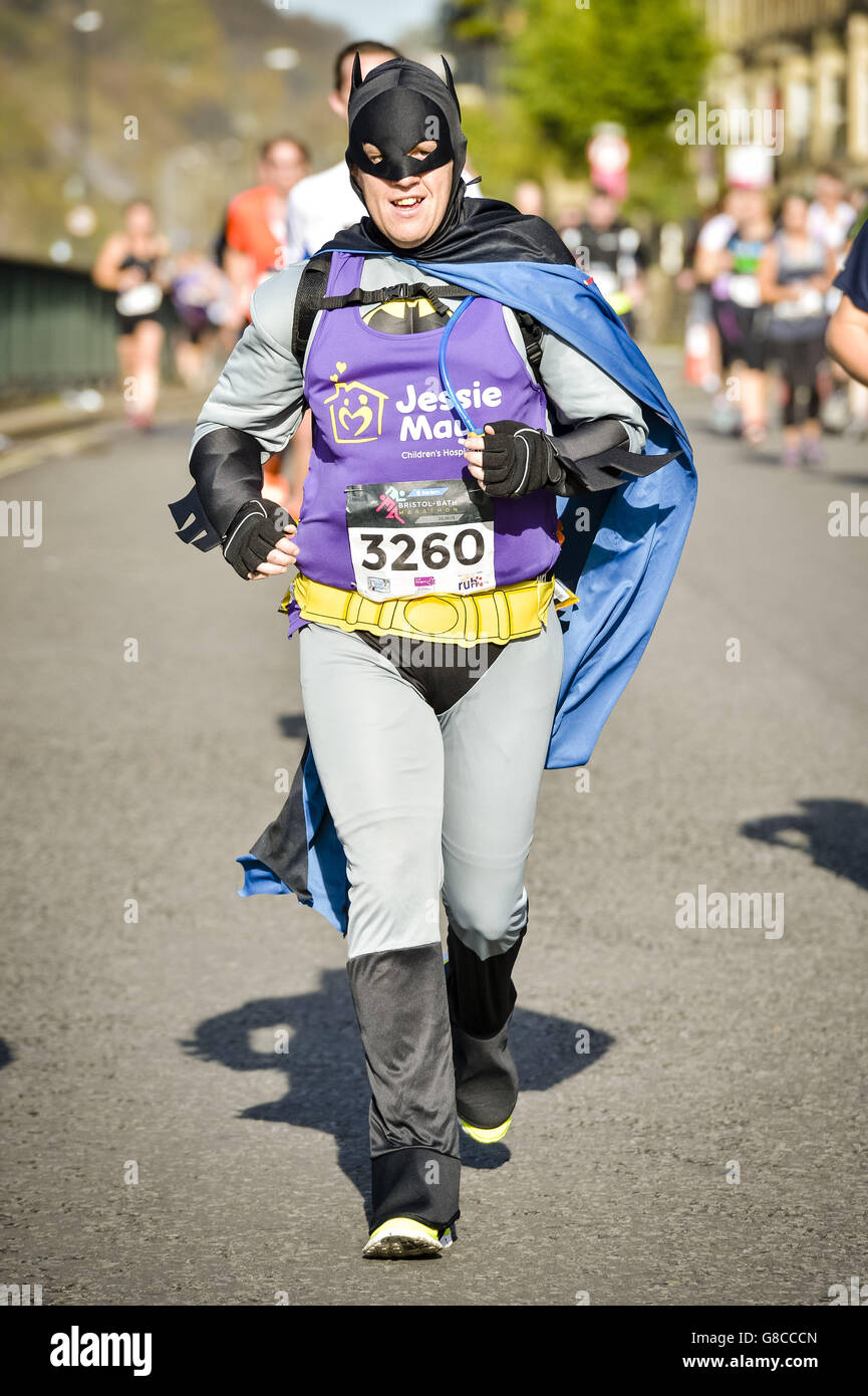 A runner dressed as Batman jogs along as thousands of runners compete in  the first ever Bristol & Bath marathon Stock Photo - Alamy