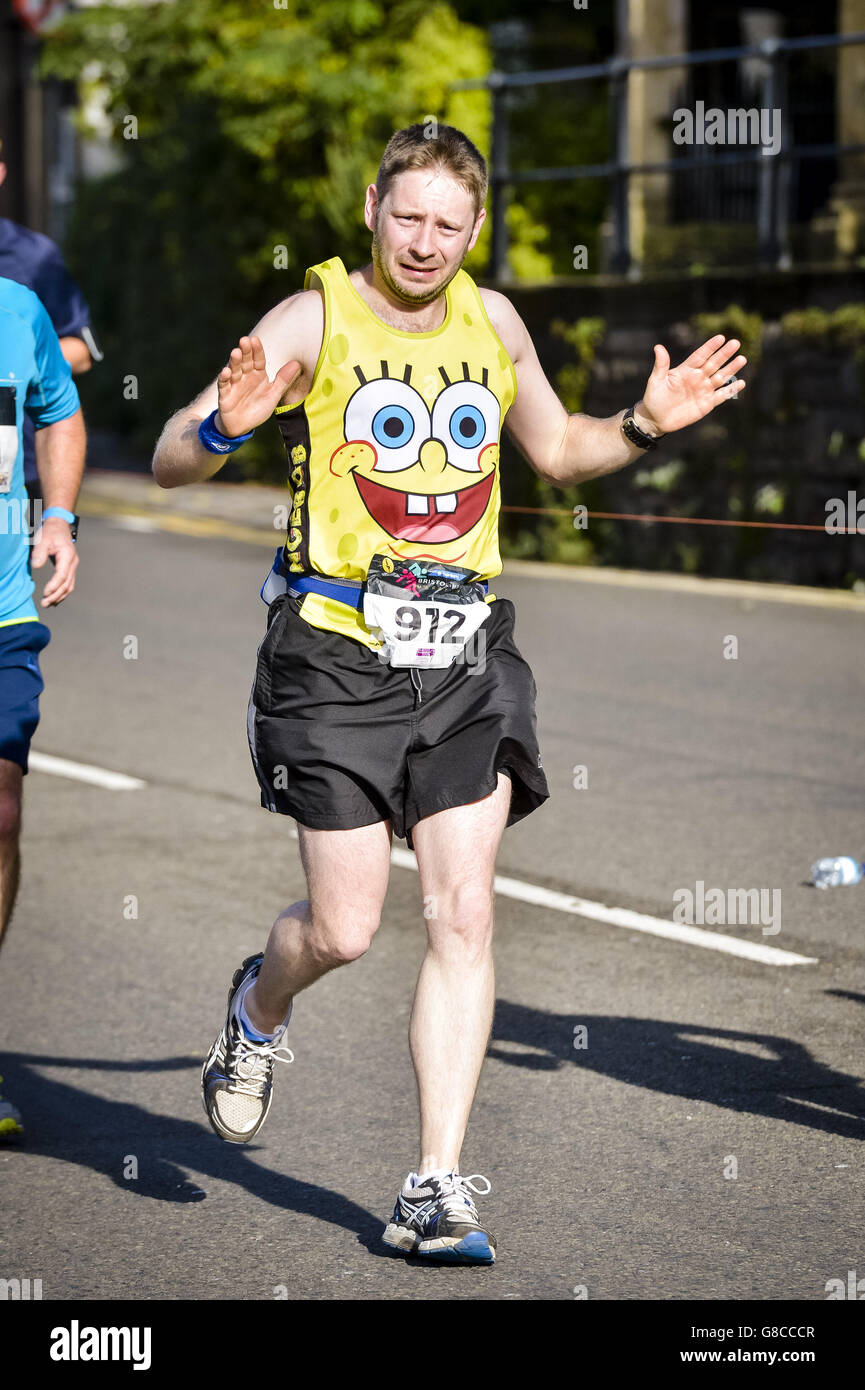 A runner with a Minion t-shirt jogs along as thousands of runners compete  in the first ever Bristol & Bath marathon Stock Photo - Alamy