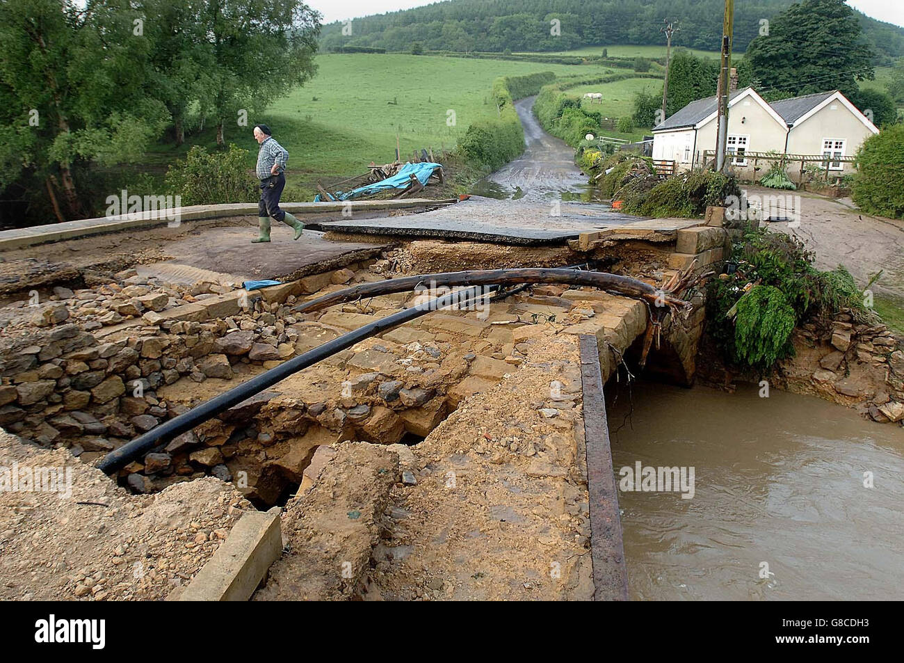A damaged bridge into the village of Hawnby, near Helmsley, following flash floods last night. Damage caused by intense flash floods which cut off parts of Yorkshire will cost tens of millions of pounds to repair, insurers said. Stock Photo