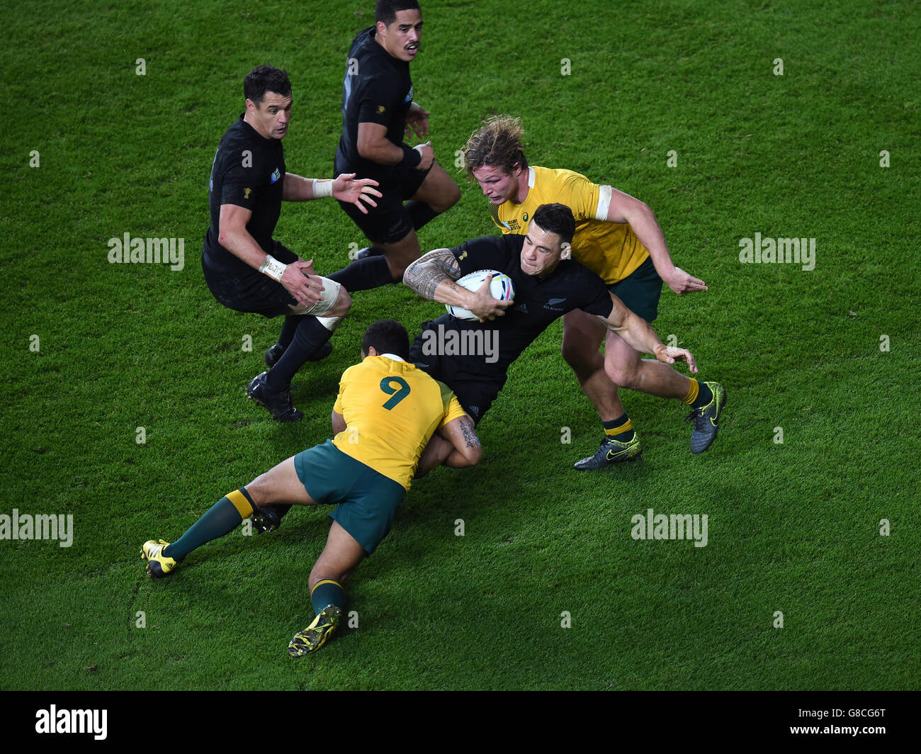 New Zealand's Sonny Bill Williams is tackled by Australia's Will Genia and Michael Hooper during the Rugby World Cup Final at Twickenham, London. Stock Photo