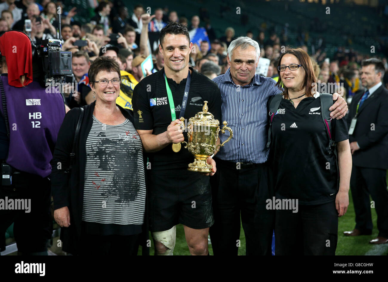 New Zealand's Dan Carter and his family celebrate with the Webb Ellis Cup after the Rugby World Cup Final at Twickenham, London. Stock Photo