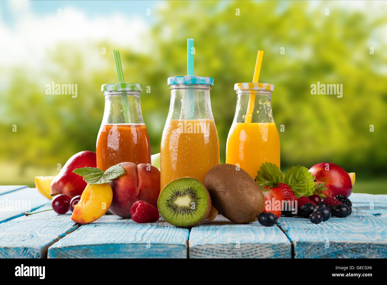 Fresh glasses of juice with fruit mix placed on wooden planks. blur garden on background. Concept of healthy drinks antioxidant Stock Photo Alamy