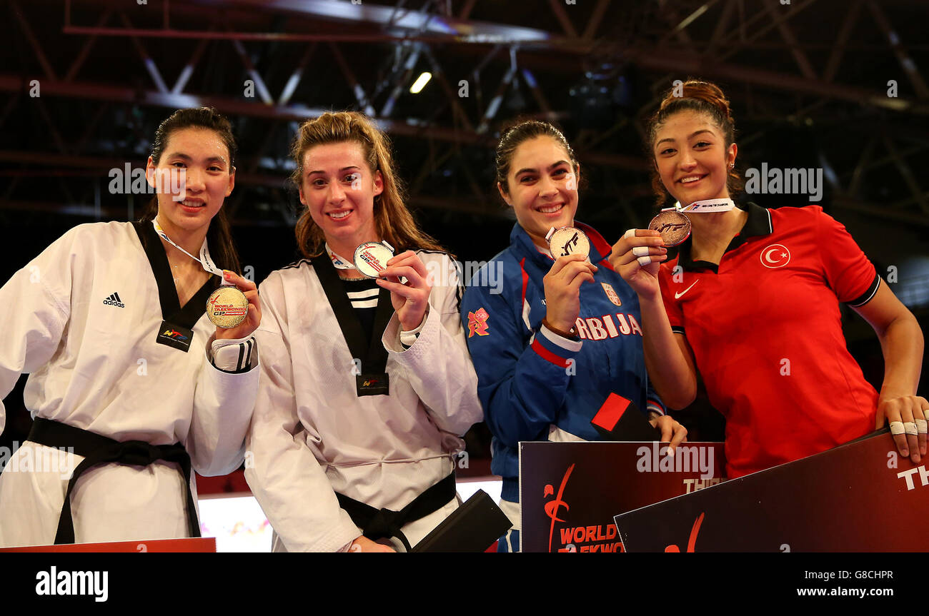 Great Britain's Bianca Walkden (second left) celebrates with her silver medal in the Women's +67 alongside gold medalist China's Shuyin Zheng (left) and joint bronze medalists Serbia's Milica Mandic and Turkey's Nafia Kus (right) during day two of the WTF World Taekwondo Championships at Manchester Regional Arena. Stock Photo