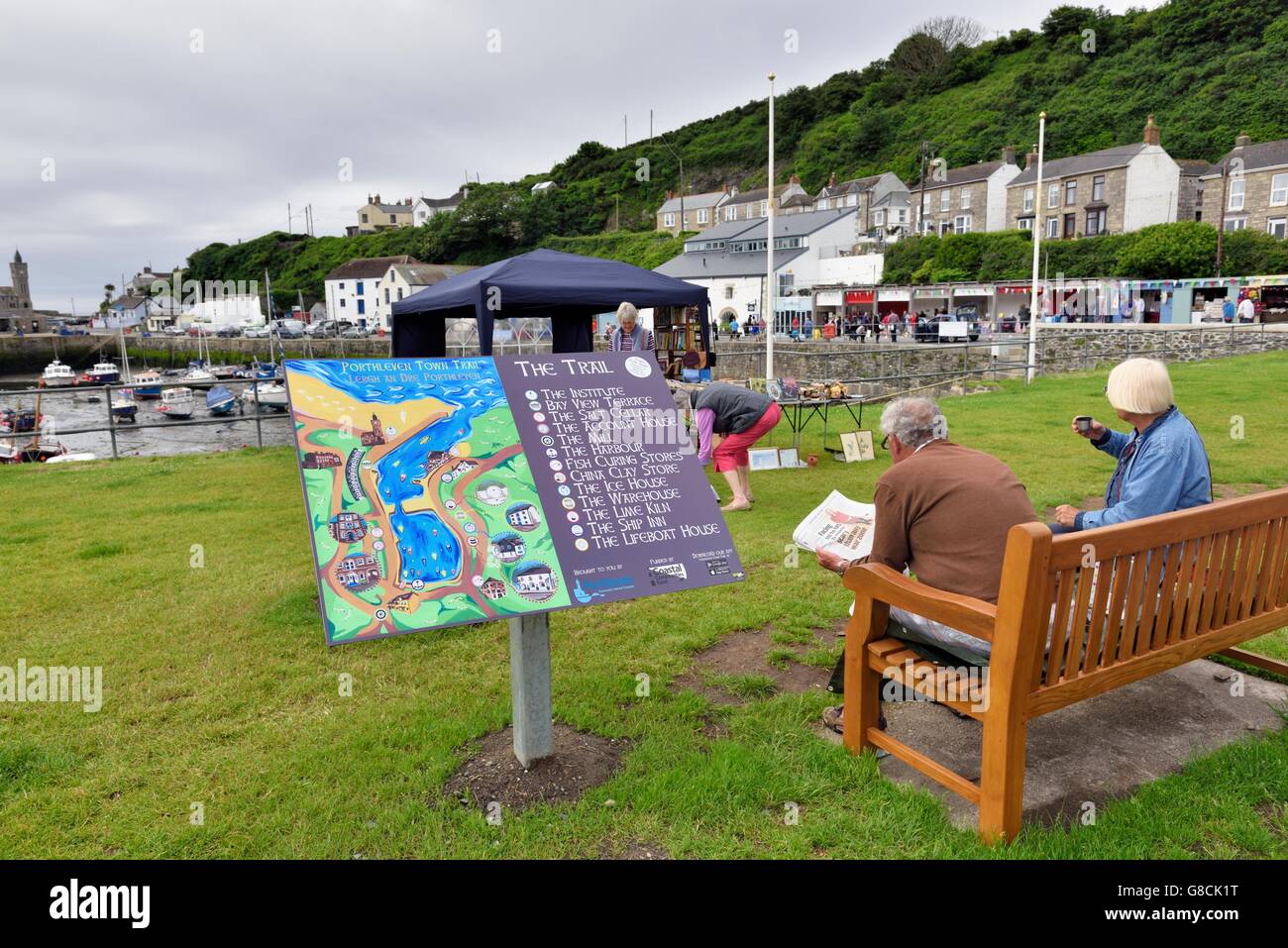 An Elderly Senior Couple Sitting On A Bench Next To The Porthleven