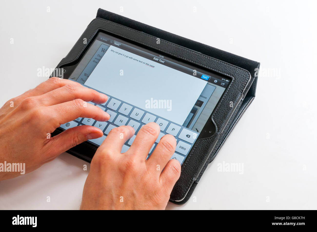 Man's hands typing on a tablet keyboard. Stock Photo