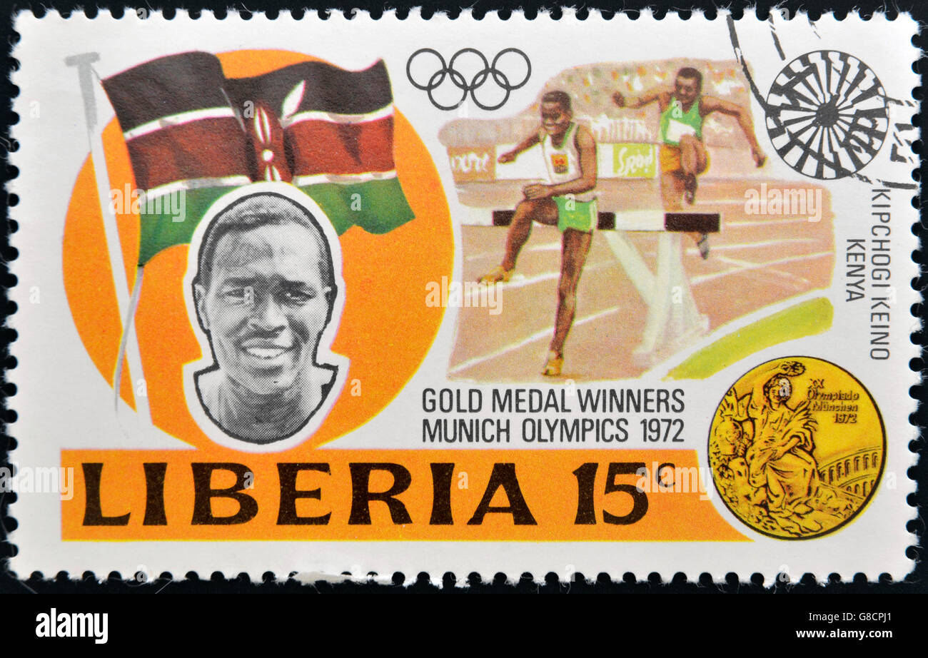 LIBERIA - CIRCA 1973: stamp printed in Liberia shows Gold medal winners in 20th Olympic Games, Kipchoge Keino, Kenya, 3000-meter Stock Photo