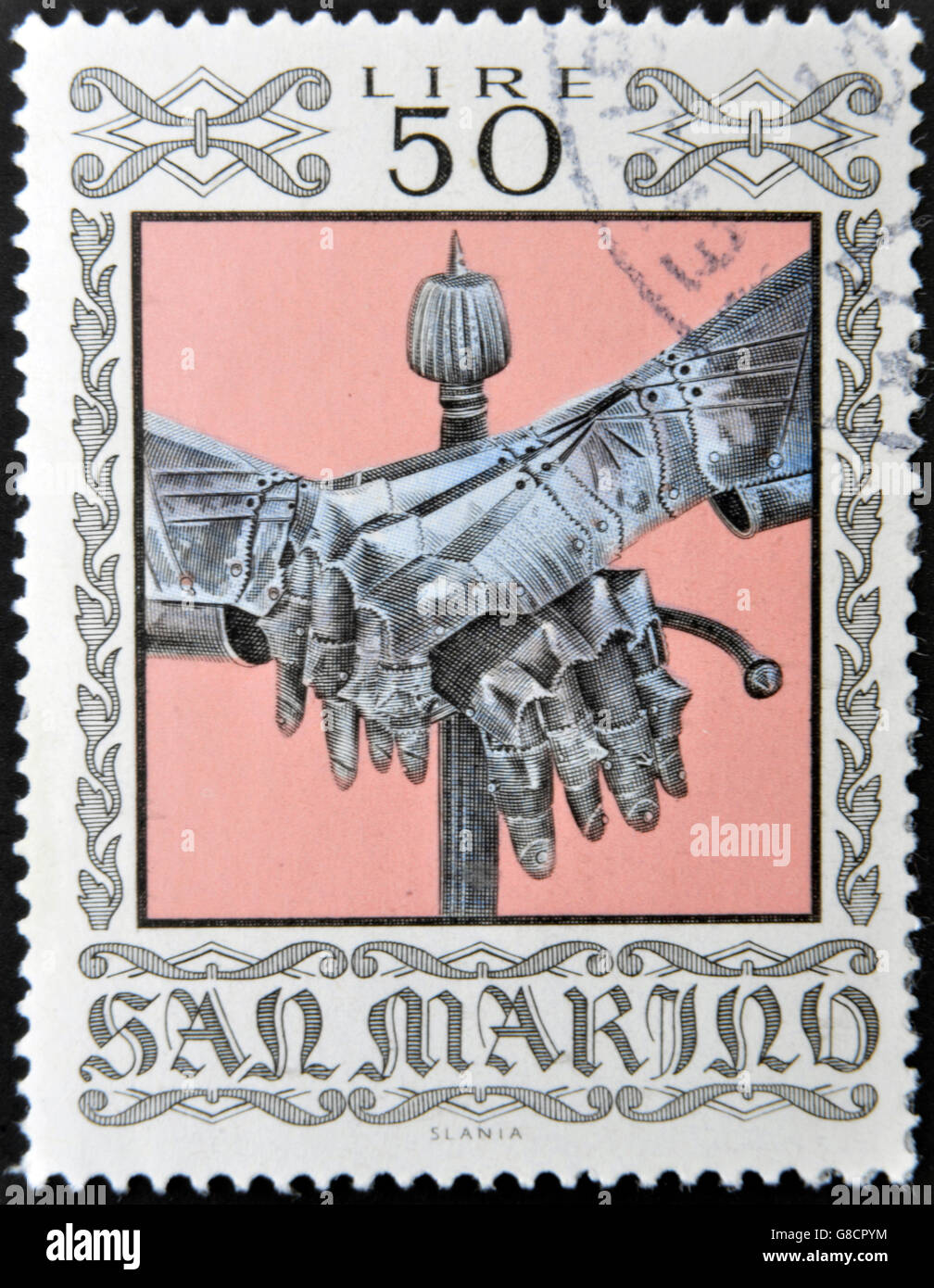 SAN MARINO - CIRCA 1974: A stamp printed in San Marino dedicated to Ancient Weapons from Cesta Museum, shows Gauntlets and Sword Stock Photo