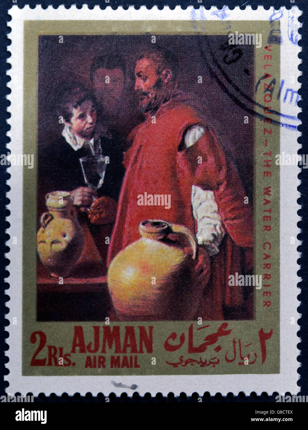 AJMAN - CIRCA 1968: A stamp printed in Ajman shows 'the water carrier' by Velazquez, circa 1968 Stock Photo