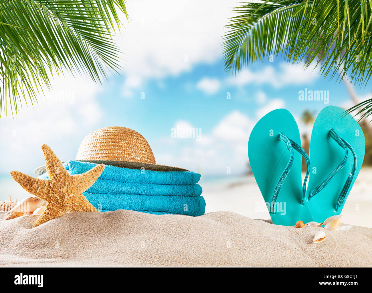 Summer accessories on sandy beach, blur sea on background. Summer exotic relaxation concept Stock Photo