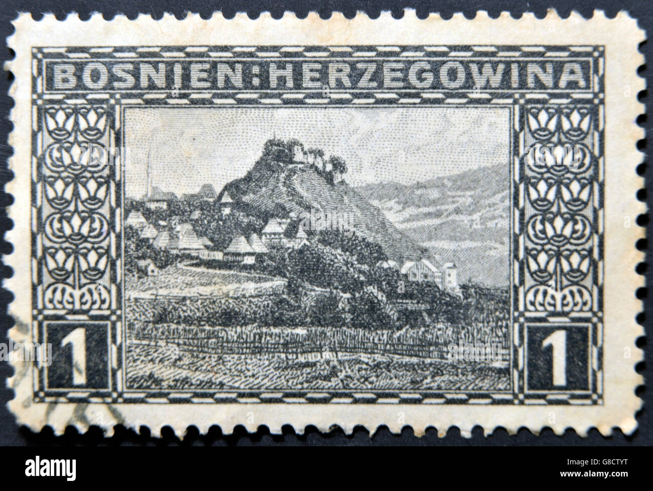 BOSNIA AND HERCEGOVINA - CIRCA 1906: A stamp printed in Bosnia and Hercegovina shows Doboj, a village in mountains, circa 1906 Stock Photo
