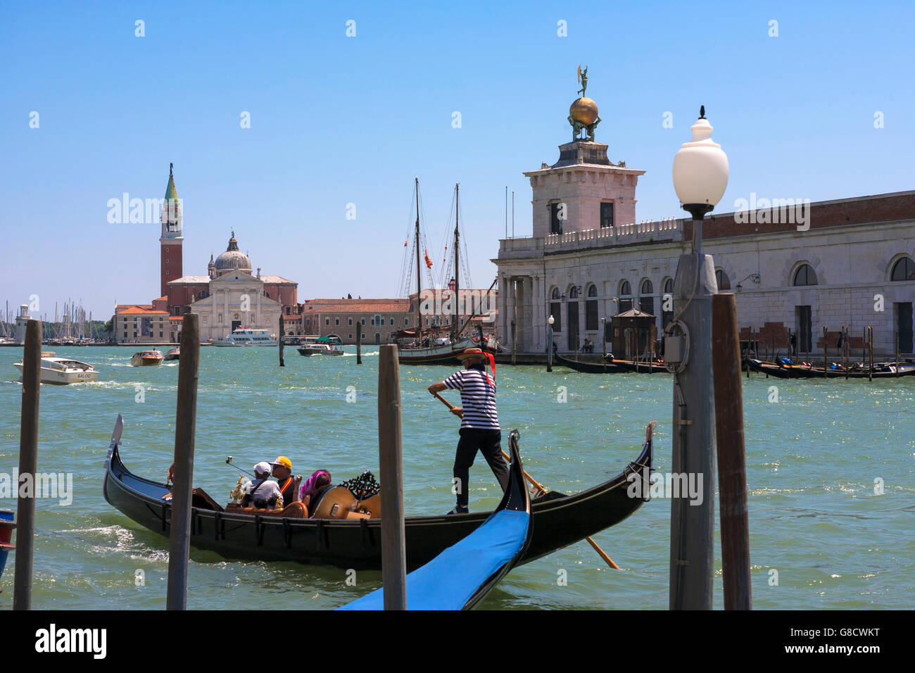 The Grand Canal, with gondola and the Chiesa di San Giorgio Maggiore beyond and the Dogana da Mar to the right: Venice, Italy Stock Photo