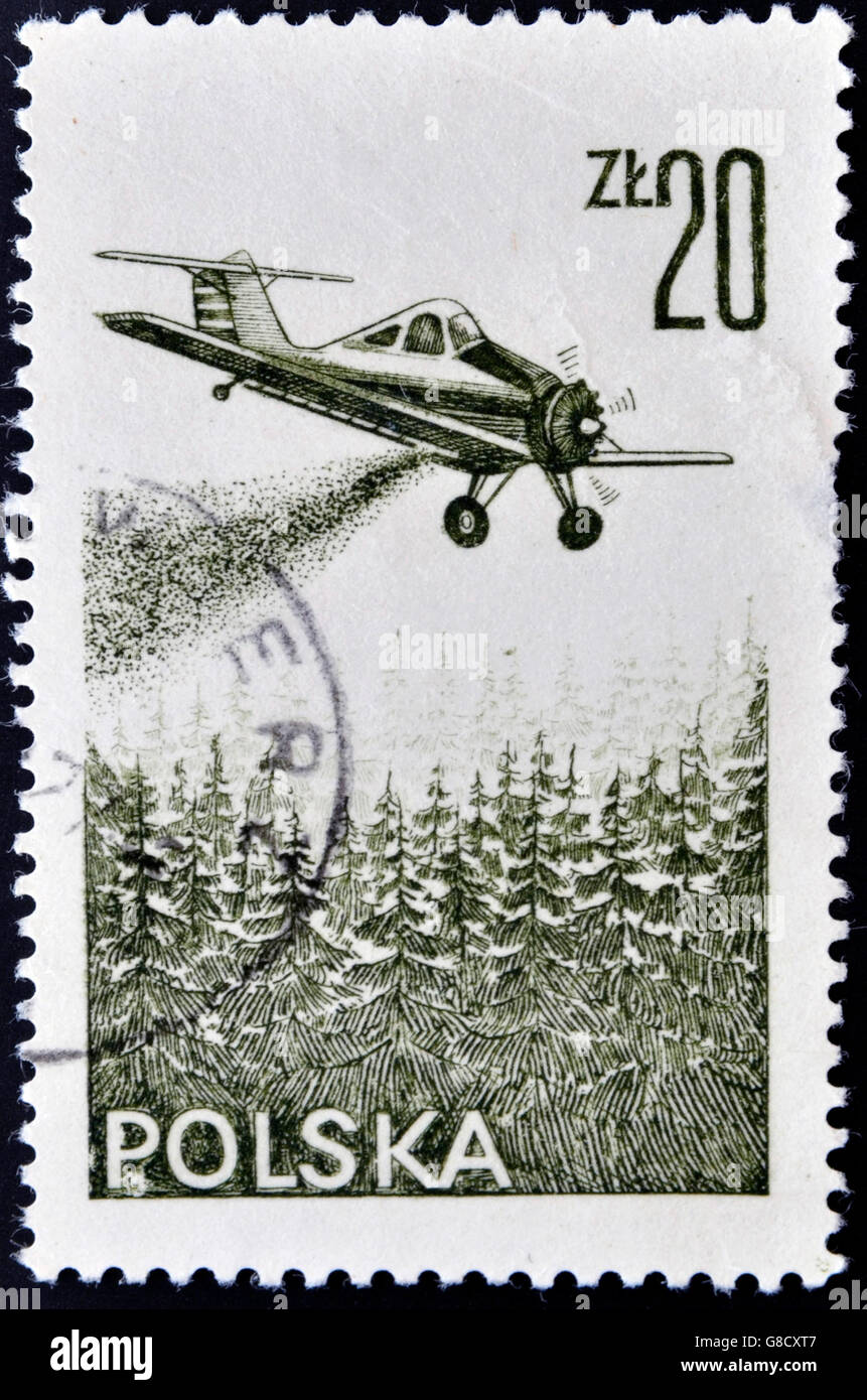 POLAND - CIRCA 1977: A stamp printed in Poland shows plane turning the mountain fire, circa 1977 Stock Photo