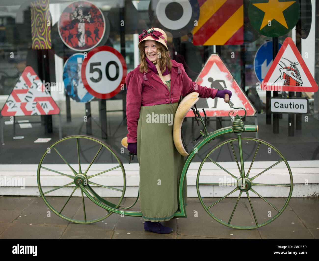 Trish Wedgwood, from Christchurch, Dorset, poses for photos on her reproduction 1819 'hobby horse' bike as a group of vintage bike enthusiasts in period costume take part in a ride through London. Stock Photo
