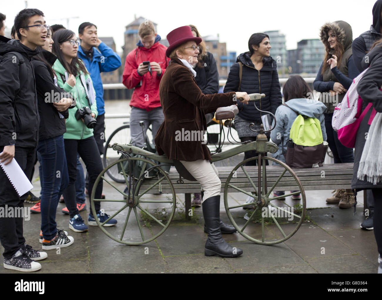 Cecilia Farren sits on her reproduction 1819 'hobby horse' bike as a group of vintage bike enthusiasts in period costume take part in a ride through London. Stock Photo