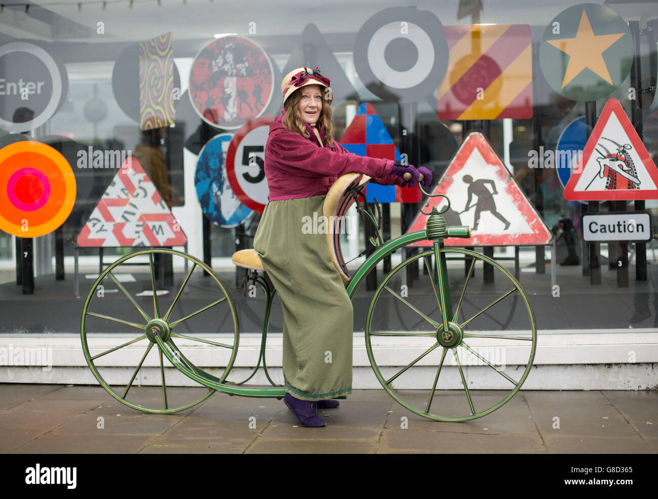 Trish Wedgwood, from Christchurch, Dorset, poses for photos on her reproduction 1819 'hobby horse' bike as a group of vintage bike enthusiasts in period costume take part in a ride through London. Stock Photo