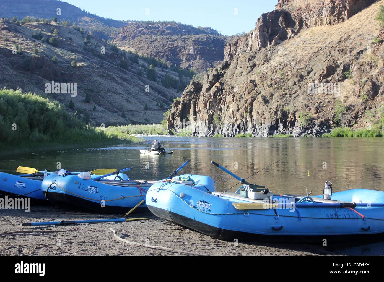 Blue river rafts resting along the John Day River, Oregon Stock Photo