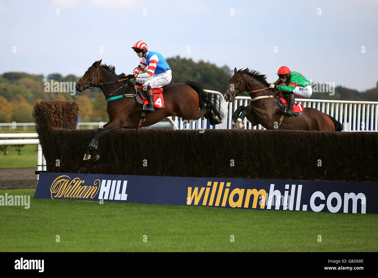 Jockey Brendan Powell on Moveable Asset (left) leads Joshua Moore on The Green Ogre during the William Hill - Download The App Store Novices' Limited Handicap Chase Stock Photo