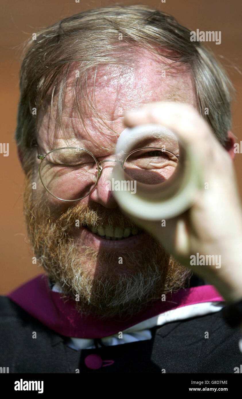 Author Bill Bryson looks through his scroll after he became a Doctor of ...