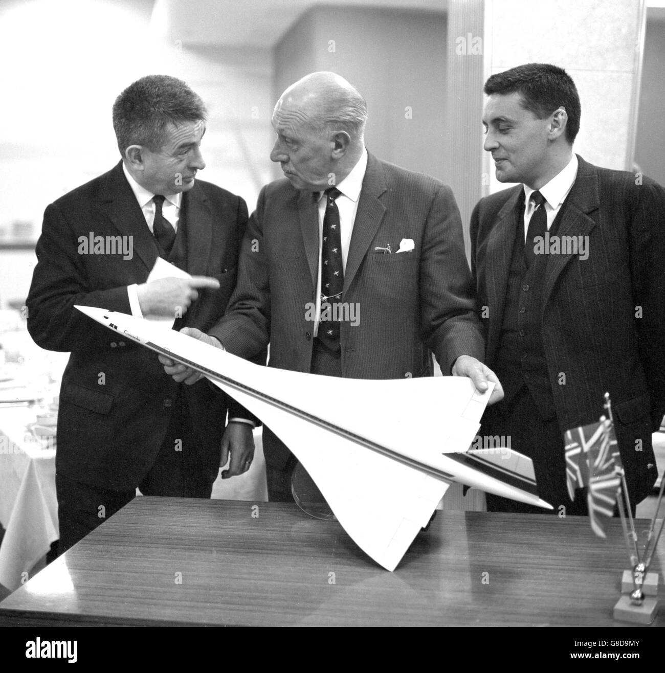 (l-r) Pierre Satre, technical director of Sud Aviation, RS Brown, production director of British Aircraft Corporation's Filton Division, and Bernard Defour, general manager Sud Aviation plants, with a model of the Concord airliner at Sud Aviation's factory at Toulouse, France. The Press were shown progress on the Anglo-French project and the first prototype is due to fly in February 1968. Stock Photo