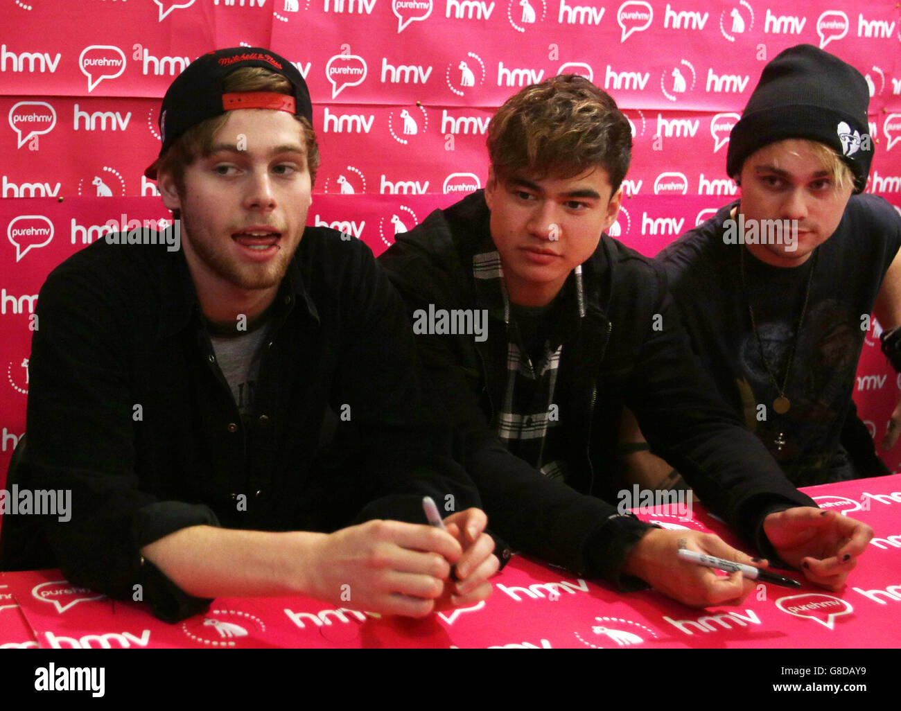 Australian band 5 Seconds of Summer (left to right) Luke Hemmings, Calum Hood and Michael Clifford during a signing session at HMV Glasgow for their new album, Sounds Good Feel Good. Stock Photo