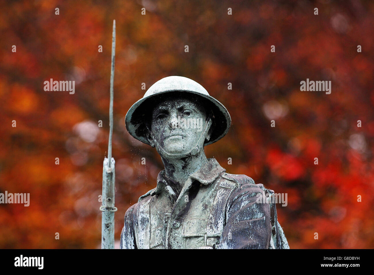 A soldier of the Great War on the War Memorial at Shildon, County Durham, against a backdrop of trees in autumn colour, as the nation prepares to remember its fallen service men and women with Remembrance Services to be held across the UK over the next few days. Stock Photo