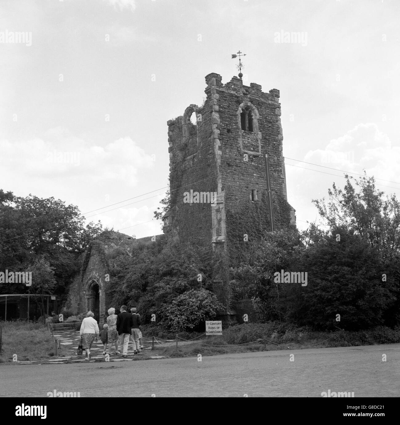 Visitors enjoy the old parish church of All Saints on the site of a Roman temple in the grounds of Stanway Hall, Colchester, Essex, a 16th century mansion built in the reign of Henry VIII. Stock Photo