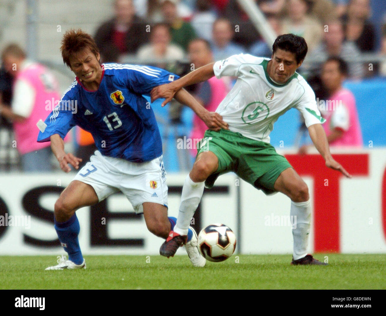 Japan's Atsushi Yanagisawa battles for possession of the ball with Mexico's Ricardo Osorio Stock Photo