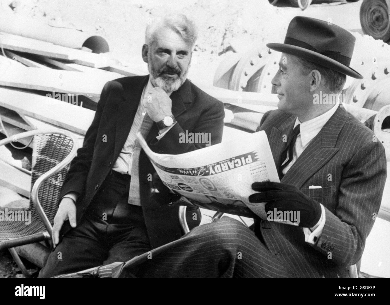 Actor Peter O'Toole (r) and Denis Carey, director of O'Toole's forthcoming presentation of O'Casey's 'Juno and the Paycock', enjoy a chat. Carey was visiting the actor in Paris , where O'Toole was filming in 'Night of the Generals'. Stock Photo