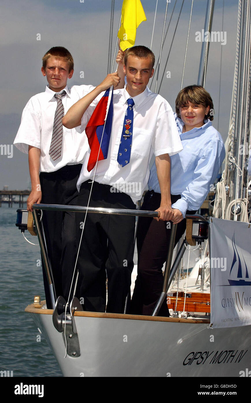 Teenagers representing youth charities (L-R) Robert McClaren, 16, from Peckham, south London, Peter Heggy, 17, from Plymouth, and Karen Smith, 17, from the Isle of Wight on Gipsy Moth IV, on which Sir Francis Chichester circumnavigated the globe, after it was re-launched following refurbishment by its original builders. Stock Photo