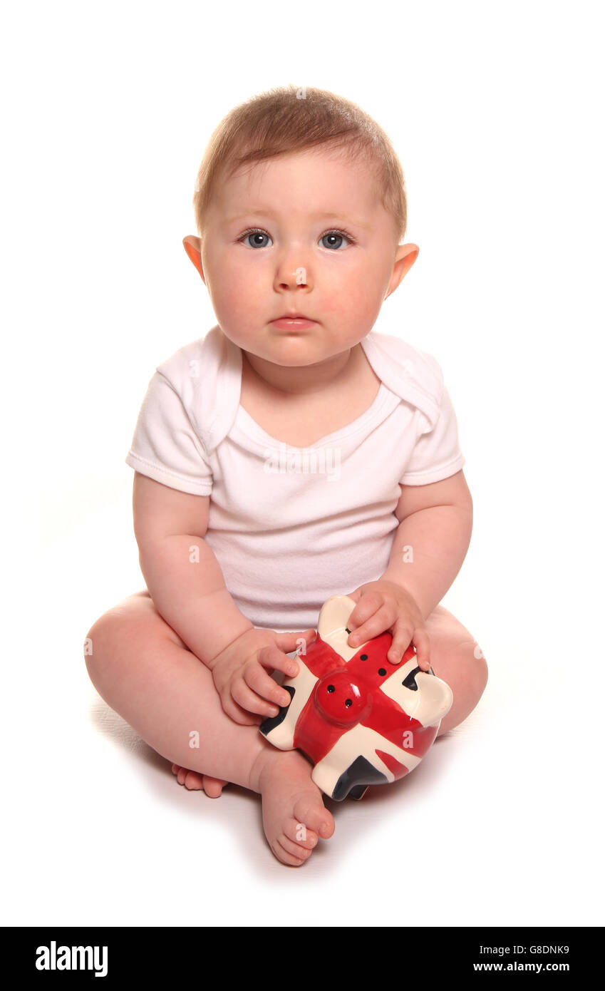 Baby girl looking sad with british piggybank cutout Stock Photo