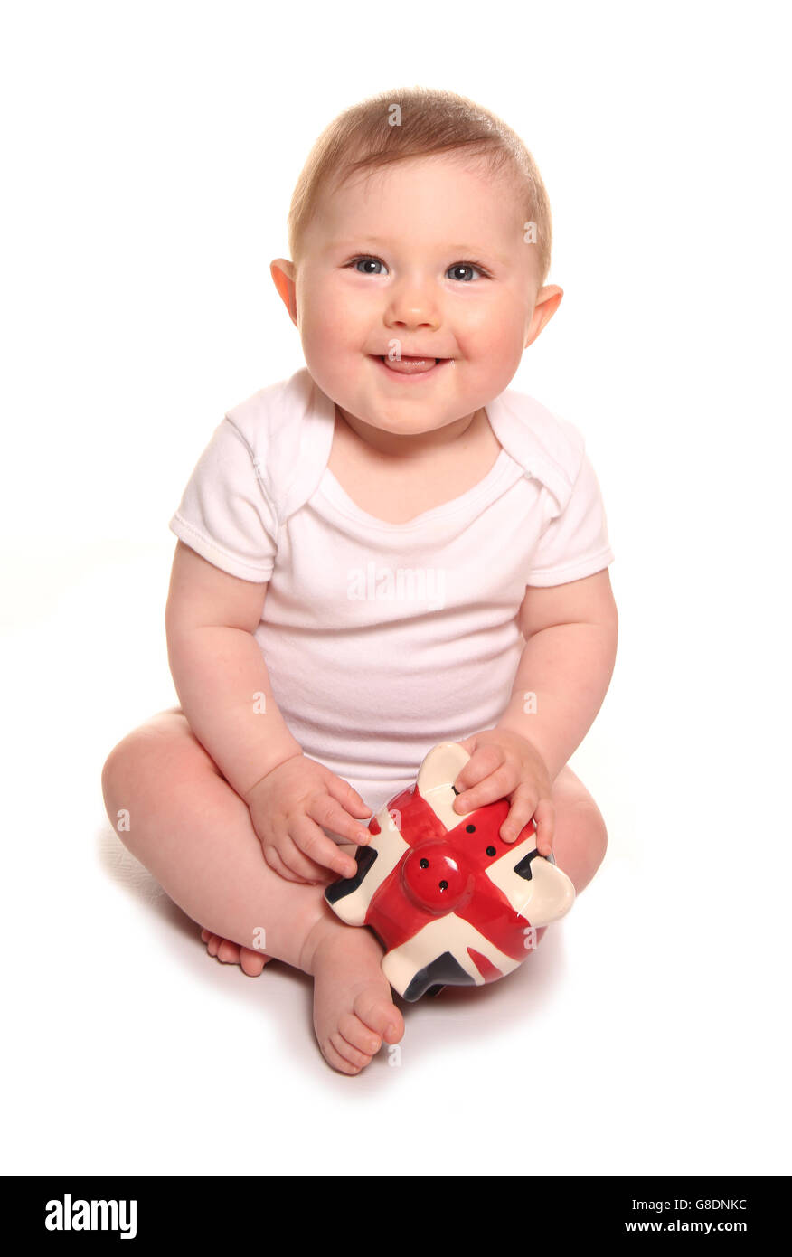 Baby girl looking happy with british piggybank cutout Stock Photo