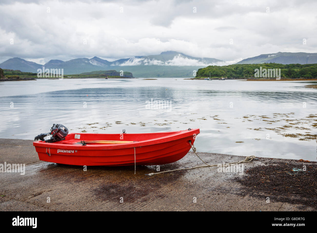 Small red dingy pulled up on a slipway, Isle of Ulva, Mull, Scotland Stock Photo