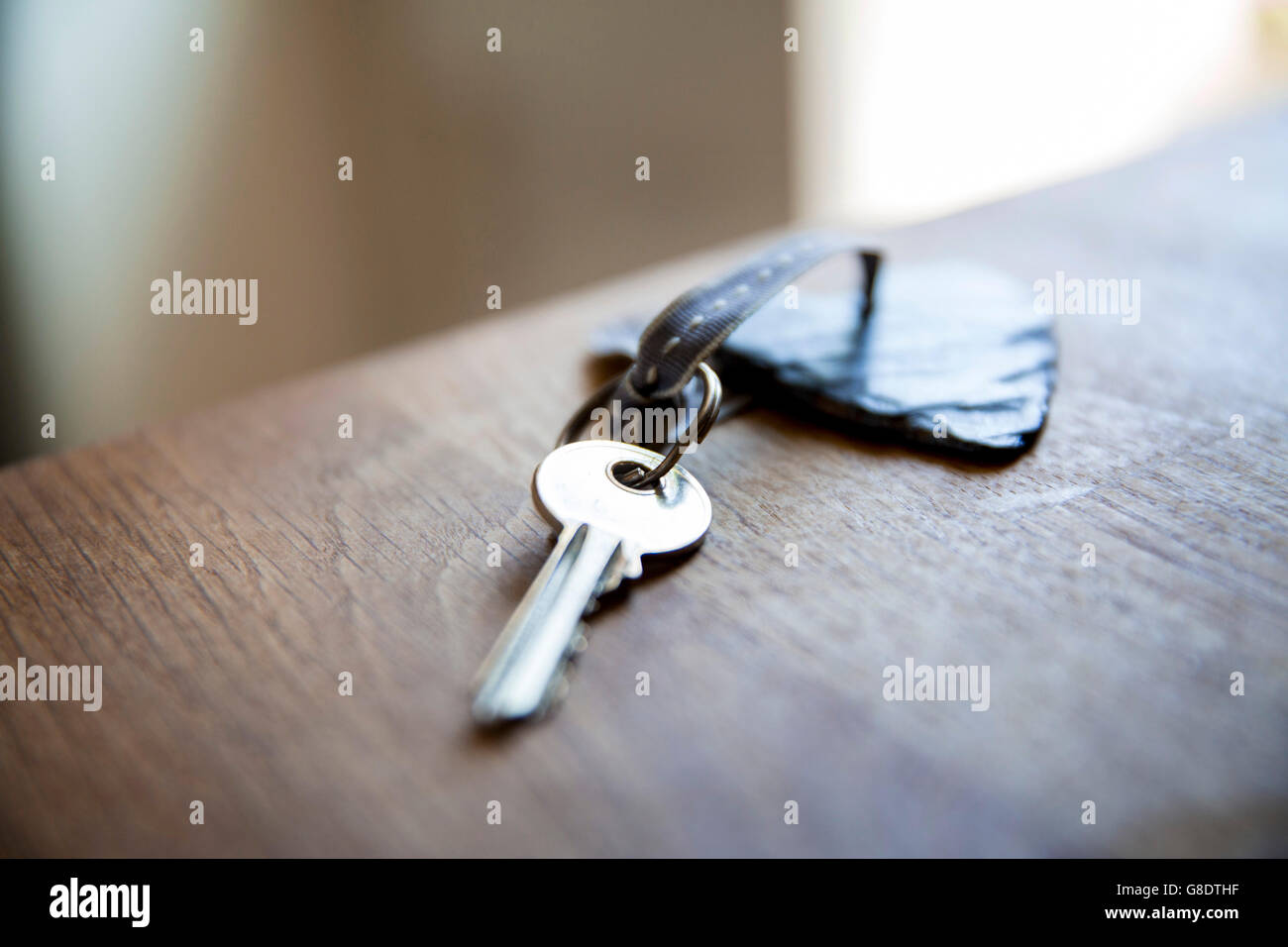 key on wooden worktop Stock Photo