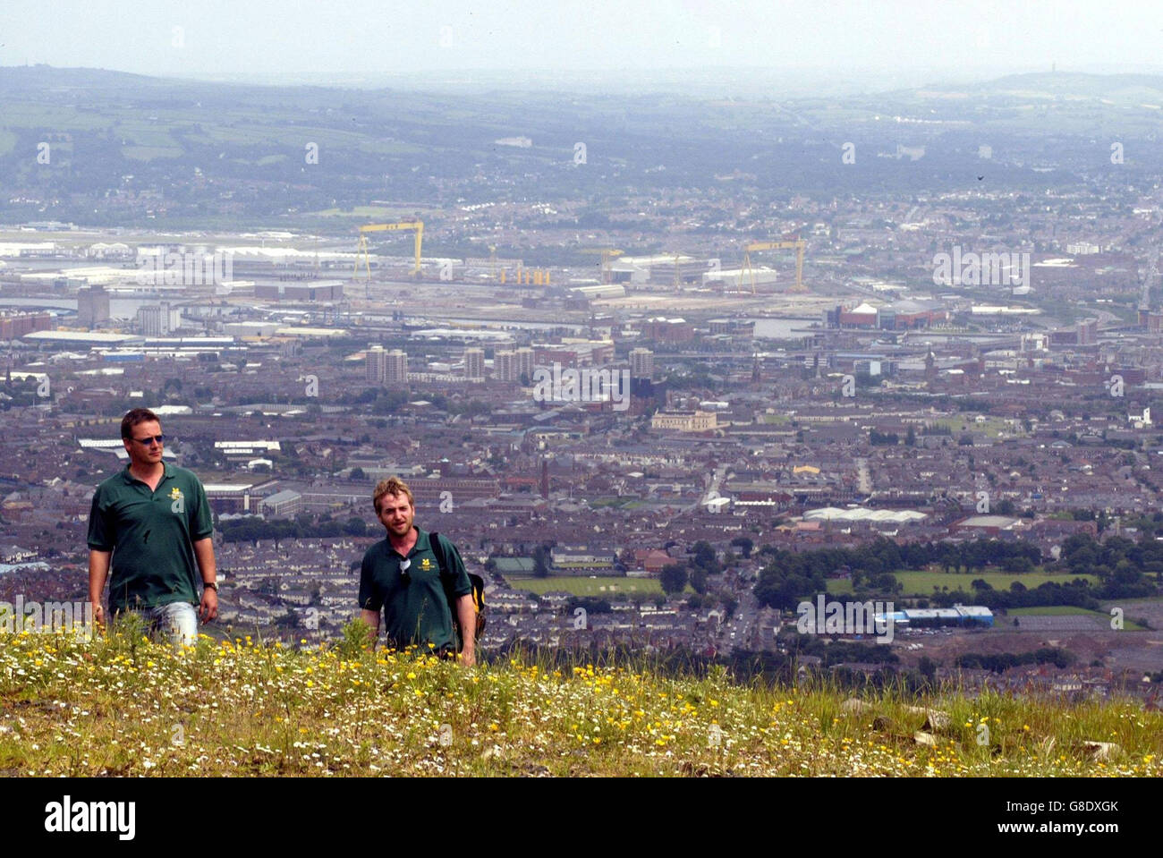 Walkers on the newly opened Divis and Black Moutains, which overlook Belfast. The National Trust bought Divis and the Black Mountain last November from the Ministry of Defence with the range of hills once used by the Army to spy on terrorists in the city. 1,500 acres of moor and heath land was opened to everyone today. Stock Photo